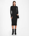 A woman faces forward wearing the Rudsak AGNES - 8524551 Black bodycon stretch dress with black ankle boots and a shoulder bag against a plain white background.