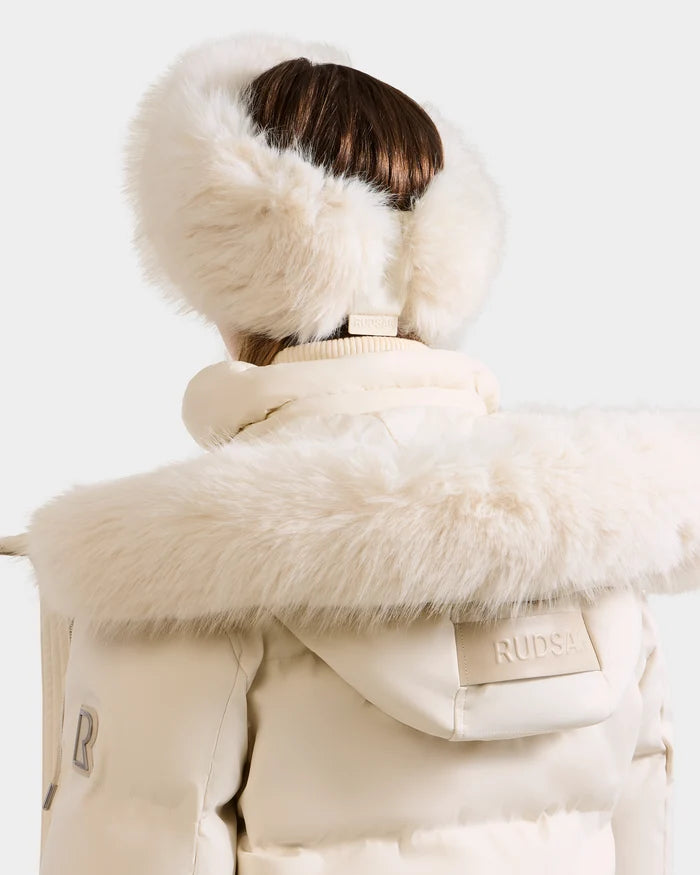 A person in the Rudsak ARLETTE - 8425544 Vanilla coat with a faux fur-trimmed hood and fluffy earmuffs, viewed from behind, embodies cozy-chic style—the perfect winter accessory look.