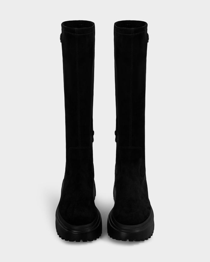 The AVOLA - L225514 Black boots by Rudsak are black, mid-calf faux-suede boots with thick, rugged soles, shown front-facing against a plain light gray background.