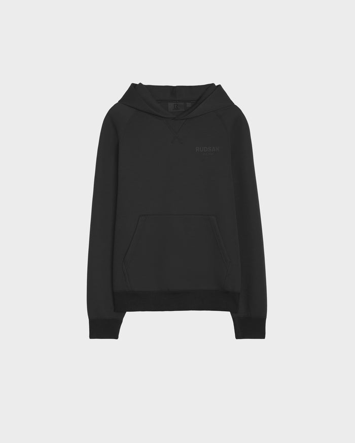 The BARRY - 9524011 Black M by Rudsak is an oversized black hoodie with long sleeves, a front kangaroo pocket, and a subtle logo on the left chest, shown against a light gray background.