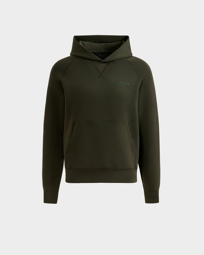 The BARRY - 9524011 Dark Olive W by Rudsak is an oversized olive green hoodie with long sleeves, a front kangaroo pocket, and the Rudsak logo on the left chest, shown against a plain light gray background.