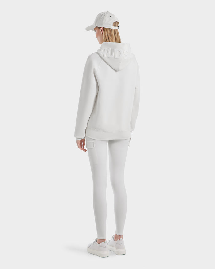 A person wearing the Rudsak BARRY - 9524011 Iceland W oversized unisex hoodie, paired with white leggings, sneakers, and a cap, stands facing away. RUDS is raised on the hood, highlighting Rudsaks signature style against a plain background.