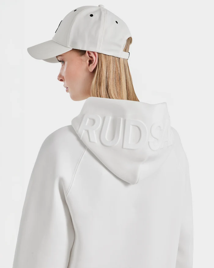 A person wears a white Rudsak BARRY - 9524011 Iceland W unisex hoodie and matching cap with the brand name embossed on the hood, shown from the back and side against a plain white background.