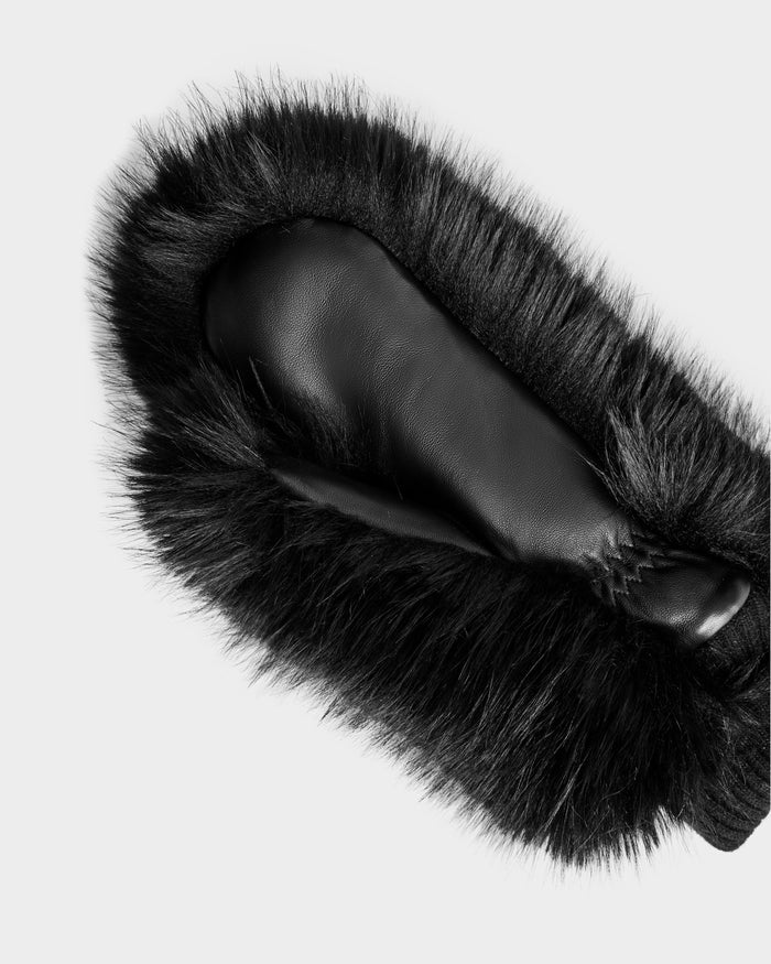 The Rudsak BELLA - 8425006 Black mitten, crafted in black leather with thick faux fur trim, is shown palm-up on a white background—an elegant winter accessory.