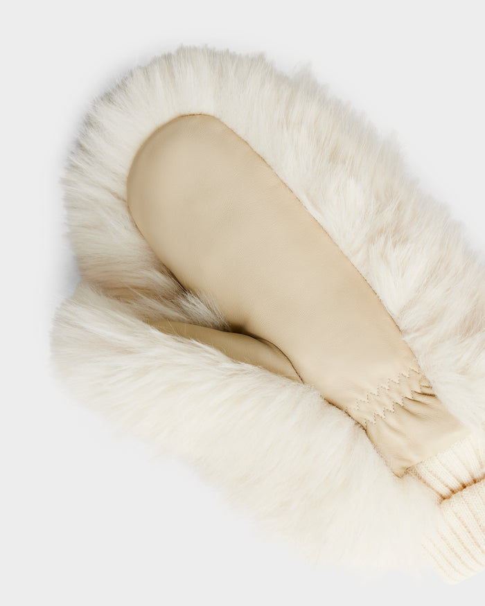 A close-up of the Rudsak BELLA - 8425006 Vanilla winter glove, featuring a cream hue, leather palm, and faux fur-lined cuff—an elegant après-ski accessory—shown against a plain white background.