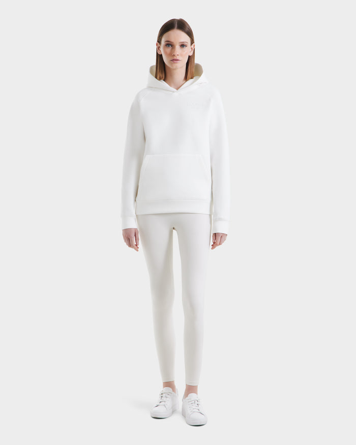 A person faces forward in the Rudsak BRIAR - 9525001 Iceland W hoodie, leggings, and sneakers—crafting a clean, casual style against a plain white background.