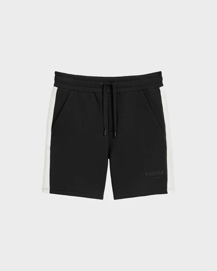 The Rudsak CAMDEN - 6525028 Black men’s jogger shorts feature white side panels, an elastic waistband, drawstring, side pockets, soft cotton-blend fabric, and a subtle RUDSAK logo on the front left leg. Perfect for your casual wardrobe.