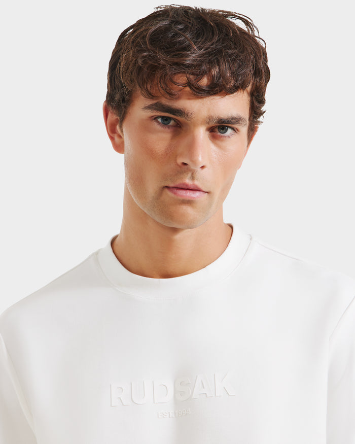 A man in the Rudsak CASEY - 6525037 Optic White mens T-shirt.