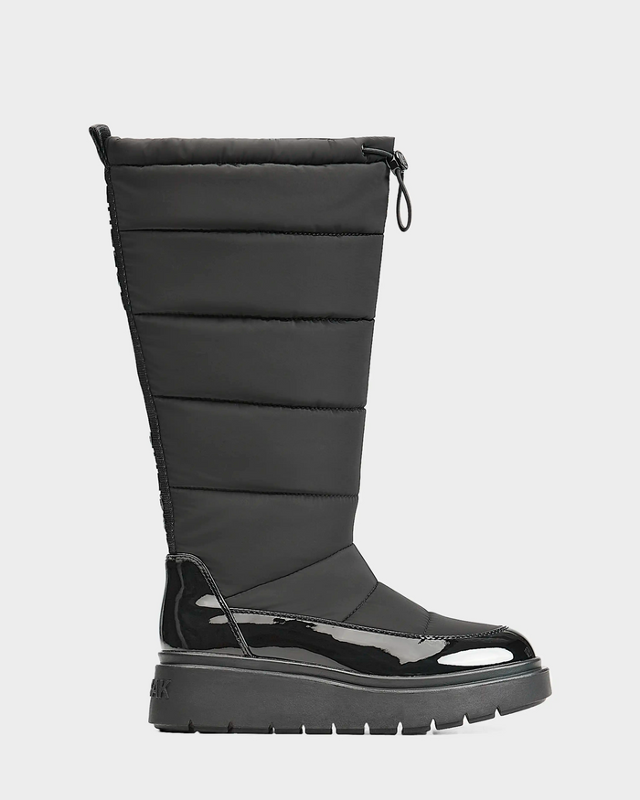 A single Rudsak CLAUDE - L223506 Black womens tall quilted winter boot with a black quilted upper, glossy patent lower section, thick ridged sole, and top drawstring closure. Shown from the side against a plain background.