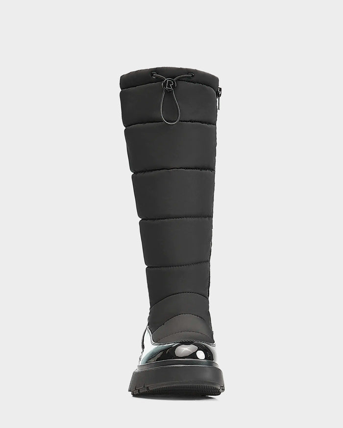 Front view of the Rudsak CLAUDE - L223506 Black womens tall quilted winter boot, featuring a padded, waterproof design with drawstring closure and shiny rubberized toe and sole, shown on a white background.