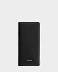 The CLEO - 9425522 Black passport holder by Rudsak features black leather and silver embossed branding near the bottom center, displayed upright against a plain light gray background—an elegant accessory for any journey.