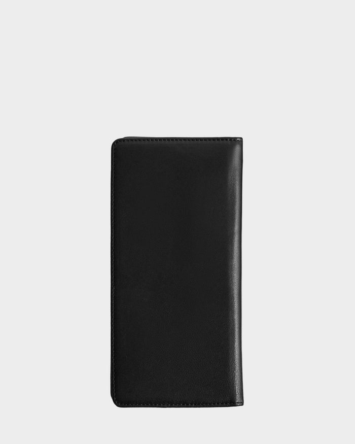 The CLEO - 9425522 Black by Rudsak, a sleek black leather unisex wallet, is shown closed against a plain light gray background—a sophisticated travel accessory.