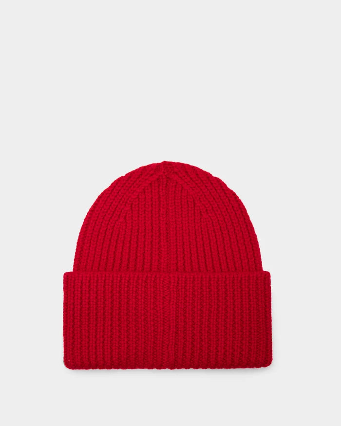 The Rudsak COLIN - 9424518 Flame Red is a unisex ribbed beanie with a folded brim, made from soft merino wool and shown on a plain light gray background.