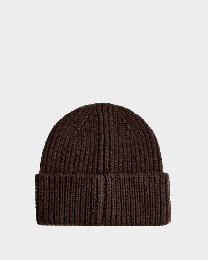 The Rudsak CYBELLE - 9424504 Espresso is a dark brown, ribbed winter beanie with a folded cuff, shown against a plain light gray background.
