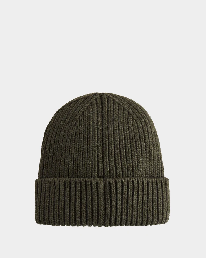 The Rudsak CYBELLE - 9424504 is a dark olive green unisex ribbed knit beanie with a folded cuff, shown against a plain white background.