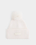 The DARA - 8425019 Vanilla by Rudsak is an off-white ribbed knit women’s tuque featuring a folded brim, a fluffy faux fur pom pom on top, and a signature RUDSAK label on the front. Crafted from a luxurious cashmere wool blend, this hat is shown against a plain white background.