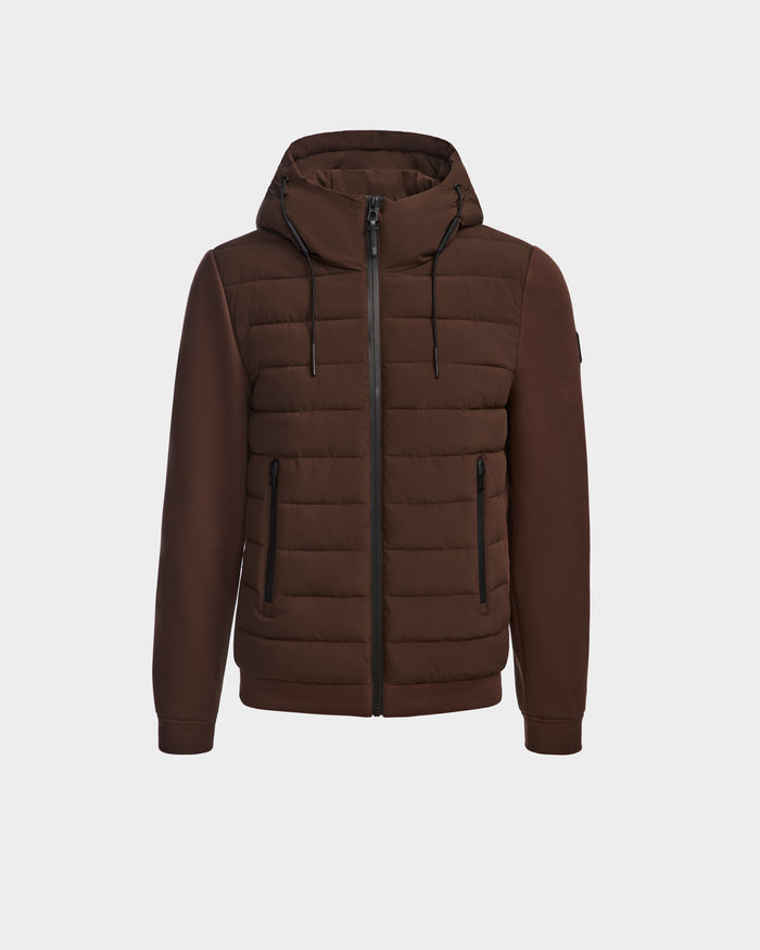 The Rudsak ELIAS - M124002 Espresso men’s quilted jacket features a brown hood, quilted panels, smooth sleeves, zippered closure and pockets. Wind- and water-resistant ecofill with a high collar and adjustable hood drawstrings.