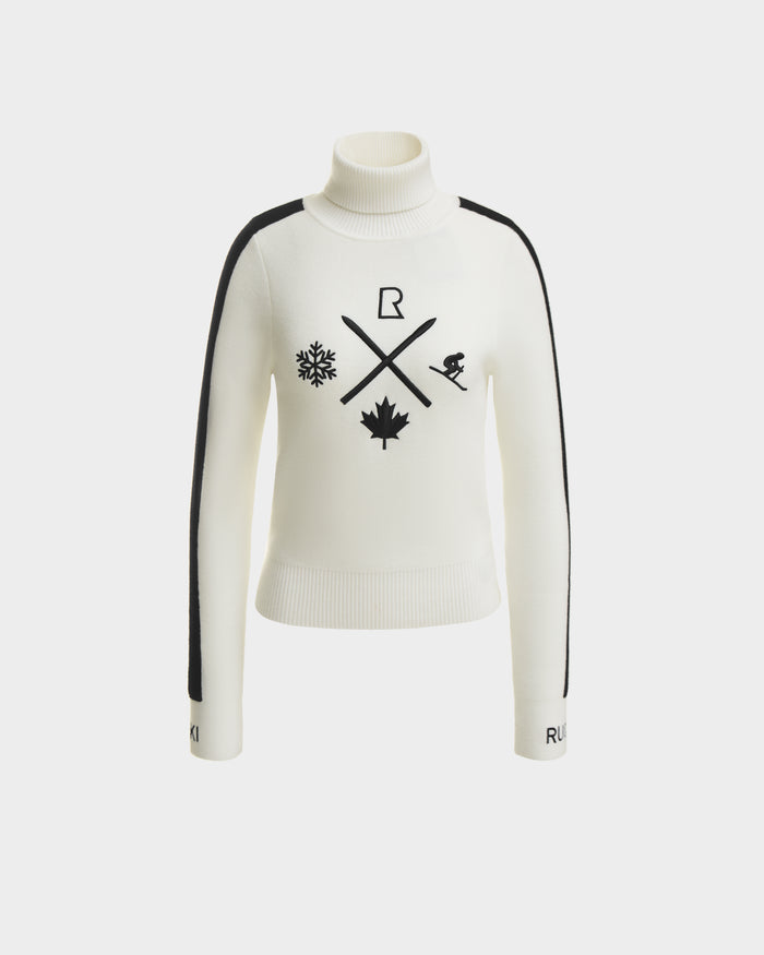 The Rudsak ELIZABETH - 8524623 Optic White is a women’s ski turtleneck featuring black side stripes, snowflake, crossed ski poles, maple leaf, skier and R logo on the front with “RUKI” accents on the sleeve cuffs—a chic après-ski pick.