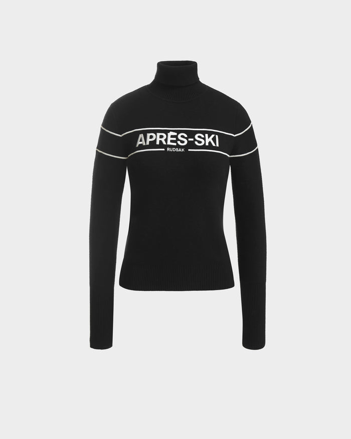The ERIKA - 8523536 Black OLD sweater by Rudsak features white stripes and bold APRÈS-SKI and RUDSAK lettering—a must-have turtleneck for your winter wardrobe.