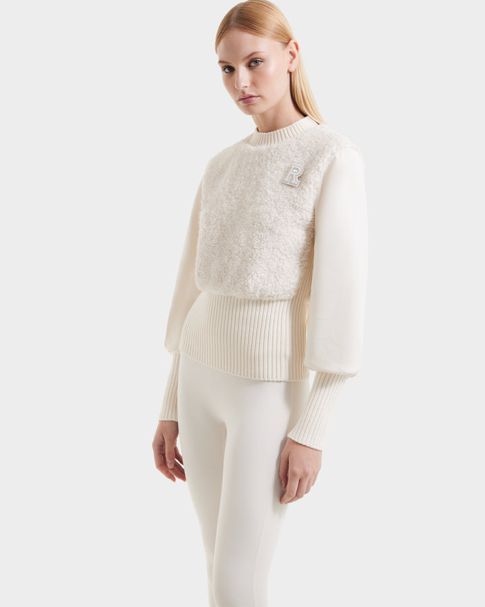 A woman with straight blonde hair models the Rudsak FLORENCE - 8525546 Iceland cream-colored textured women’s top and matching fitted pants, an après-ski essential, standing against a plain white background.