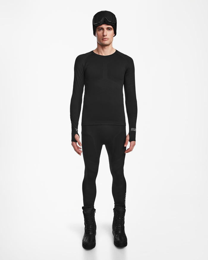 A man faces forward against a white background, wearing the Rudsak FRANC - 6524541 Black mens fitted thermal base layer set with matching leggings—ideal as a skiing underlayer.