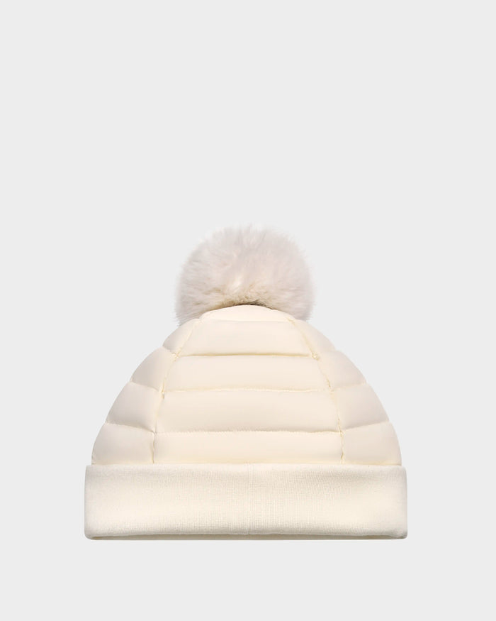 The Rudsak GALA - 8424514 Iceland is a cream women’s quilted down puffer hat with premium insulation, a wide folded brim, and removable faux fur pom pom, shown on a plain light gray background.