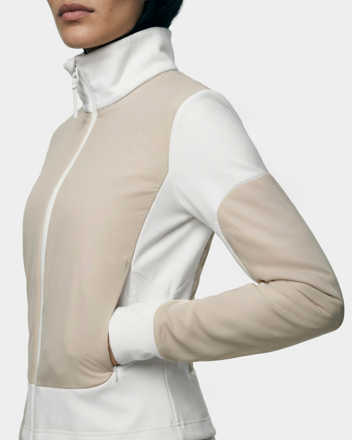 A person wearing the Rudsak GRANADA - 8126023 Vanilla sporty-chic sweater jacket with hands in side pockets, shown from chest to hips against a plain background.