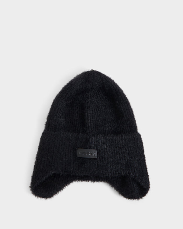 The Rudsak ICE - 8426519 Black beanie, featuring a folded brim and a rectangular black patch on the front, is displayed against a plain light gray background.