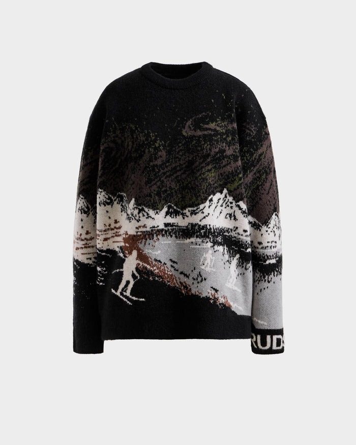 The Rudsak IZZY - 9525557 Black W is a unisex knit sweater with a ski mountain motif, snowy scenes, skiers, and "RUD" on the left cuff—ideal for après-ski events.