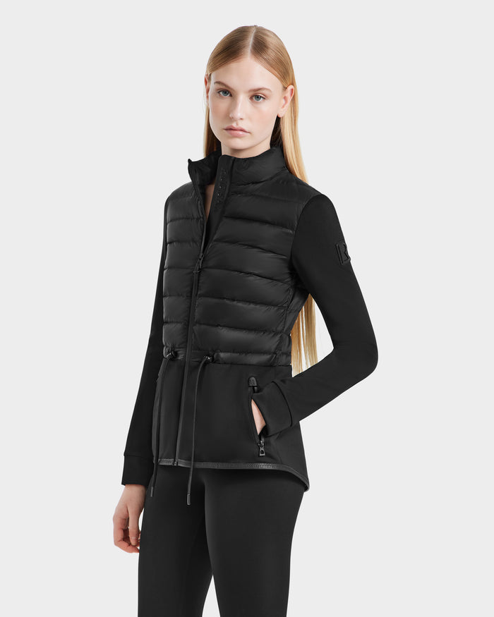 A woman in the black JOSEPHINE - L125011 jacket by Rudsak, made from recycled nylon and vegan leather.