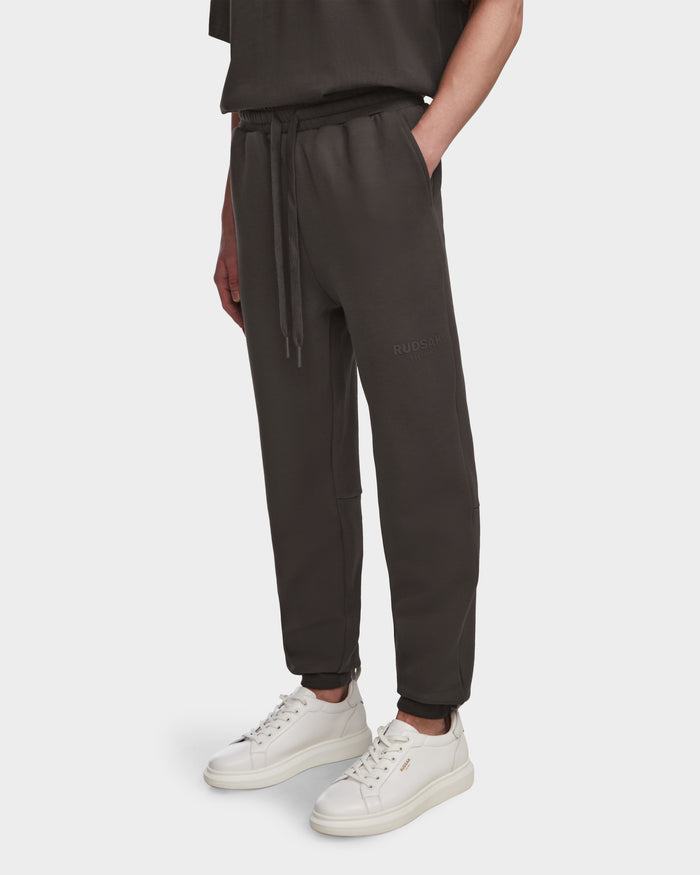 A person wearing Rudsak JOSS - 9524009 Grey M joggers and white sneakers.