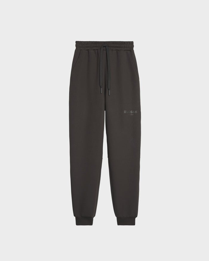 Rudsak’s JOSS - 9524009 Grey M joggers feature premium cotton, an elastic waistband with drawstring, cuffed ankles, and subtle left thigh text, showcased against a plain white background for a stylish look.