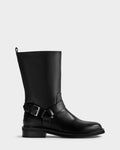 The KIRRA - 8225558 Black by Rudsak is a black leather mid-calf moto boot featuring a low heel, ankle buckle strap, and pull tab detail. Shown on a light gray background, it perfectly embodies Rudsak’s iconic leather boot style.