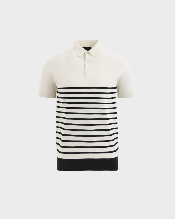 The KRIS - 6526005 Iceland by Rudsak is a cream-colored, short-sleeved polo with a collar, buttons, horizontal black stripes on the lower half, and a solid black band at the bottom.