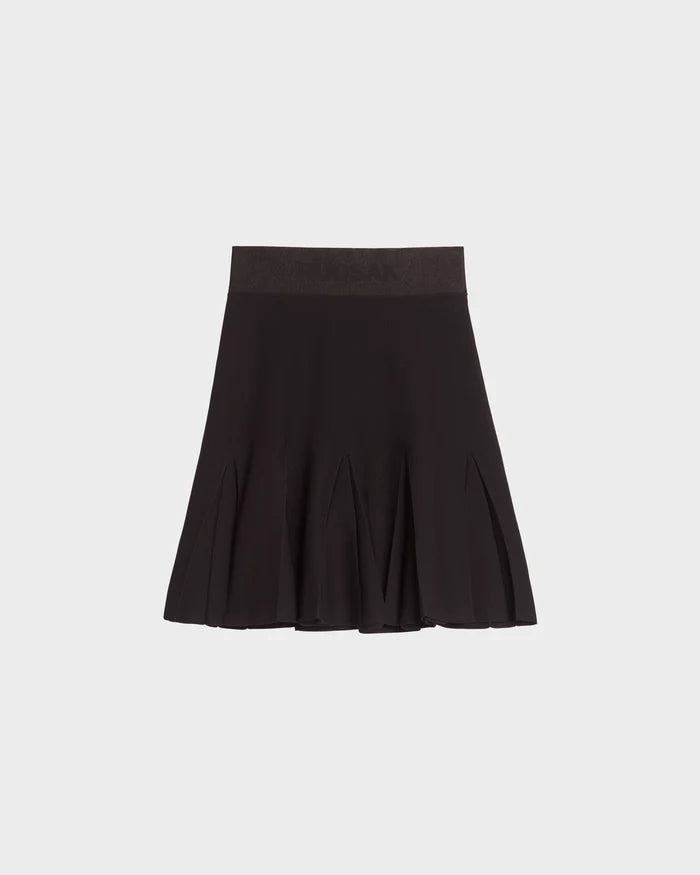 The Rudsak LEA - 8524064 Black womens knit skirt showcases sharp pleats and a wide high-waisted waistband in contour soft knit, set against a plain light gray background.