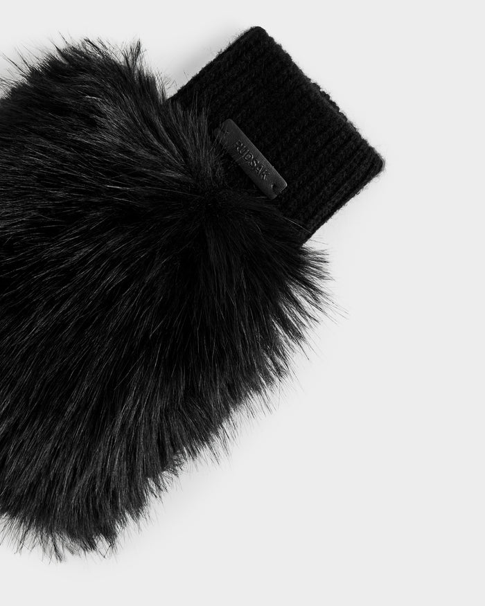 A close-up of the Rudsak LIA - 8425007 Black women’s faux fur mitten with a fingerless sleeve, ribbed wool-blend knit cuff, and small rectangular label, displayed on a light grey background.