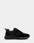 The Rudsak LIONEL - 6225001 Black is a men’s lace-up sneaker featuring black suede and smooth overlays, thick sole, black laces, and an embossed R logo on the side, offering a modern look against a light grey background.