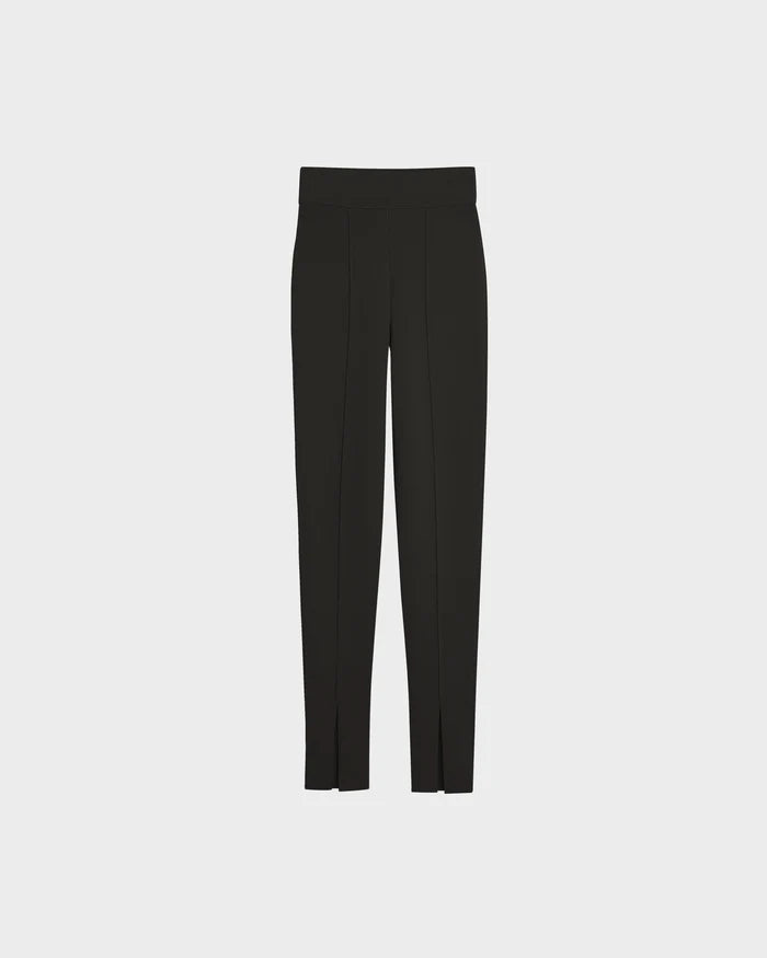 The Rudsak MATHILDA - 8524515 Black tailored pants feature a straight leg cut, subtle front seams, and small ankle slits at the hem, shown against a plain light gray background.