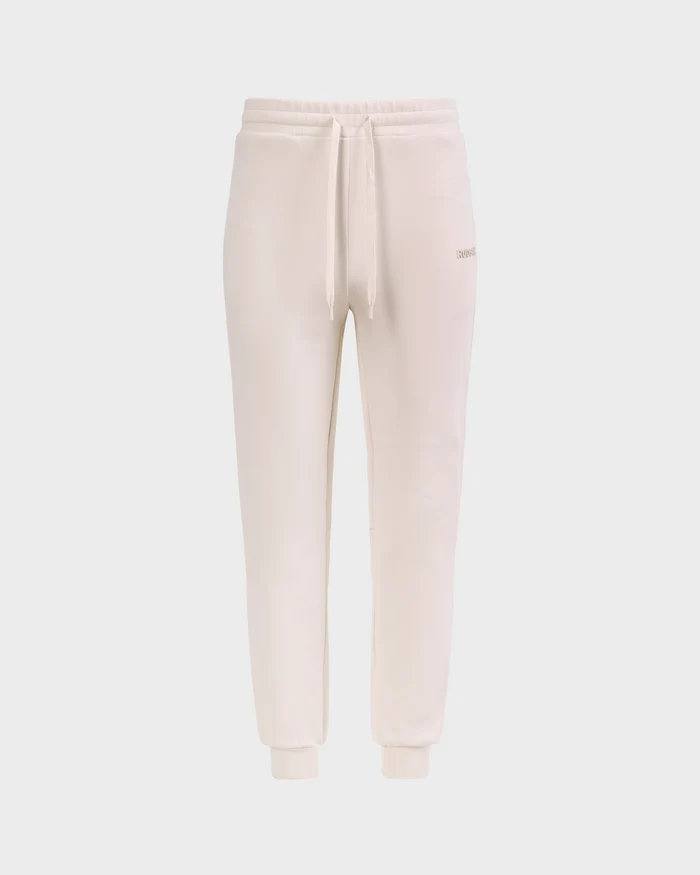 The Rudsak MAXTON - U525007 Vanilla W jogger sweatpants in a beige cotton-blend feature an elastic waistband, drawstring, and cuffed ankles for all-day comfort, shown against a plain white background.