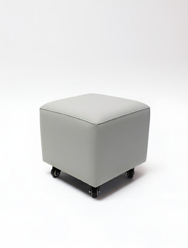 Belava Nail Tech Stool - Shorty: square gray ottoman with wheels on white background.