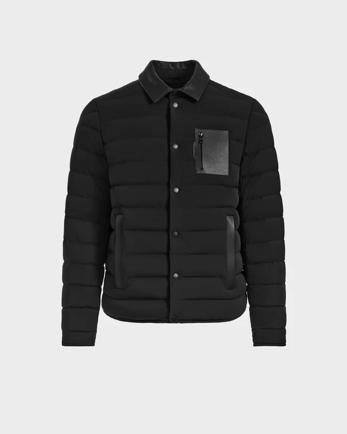The Rudsak NICHOLAS - 6125040 Black is a mens quilted shirt jacket with a collared neckline, button-down front, two side pockets, and a zippered chest pocket with leather accent—a modern wardrobe essential.