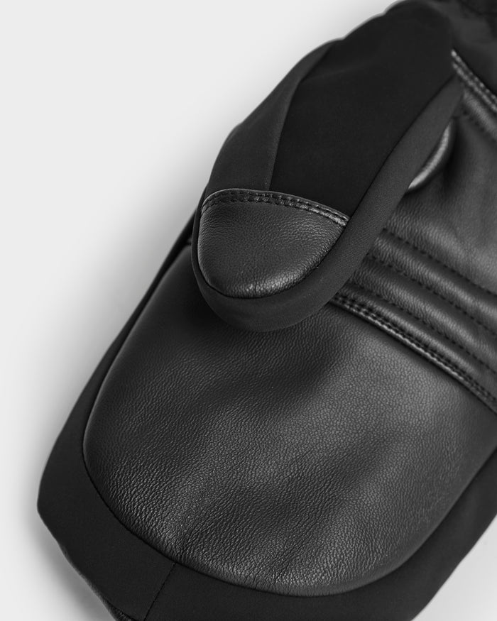 A close-up of Rudsak's OLTEN - 9425565 Black winter mitten, crafted from leather and fabric with detailed stitching and Thinsulate warmth—ideal for those seeking high-quality ski mittens.