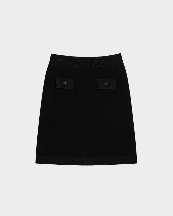 The Rudsak PANAMA - 8525075 Black is a womens fitted knit mini skirt featuring chic button accents on two front pockets, shown against a plain light gray background.