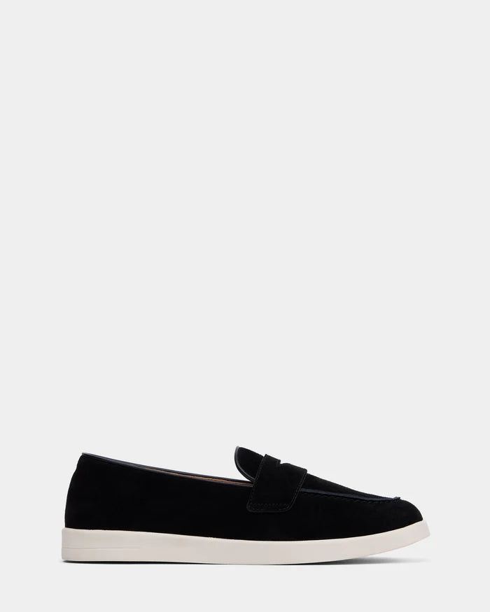The RABECCA - 8225006 Black by Rudsak is a womens luxury black suede loafer with a white rubber sole, classic slip-on design, and low heel, shown in side profile against a plain light gray background.