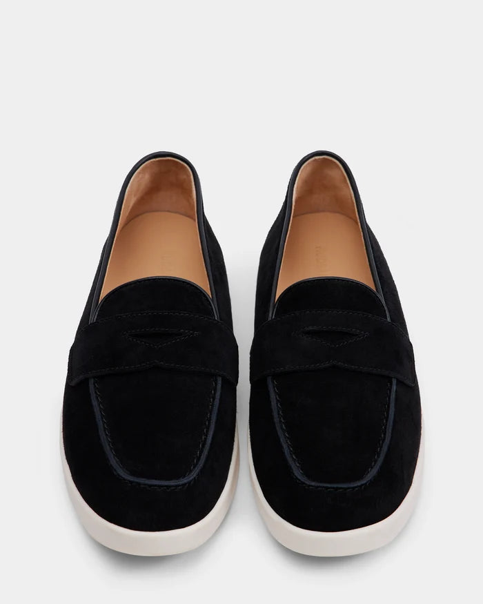 The Rudsak RABECCA - 8225006 Black is a womens luxury black suede slip-on loafer, featuring tan insoles and white rubber soles, shown from above on a plain light background.