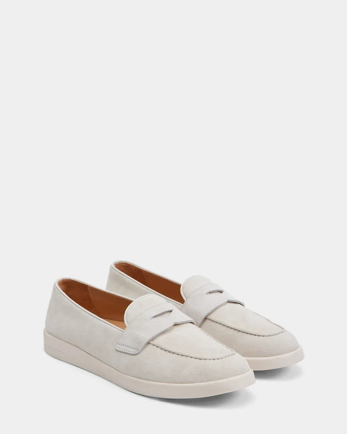 Rudsak’s RABECCA - 8225006 Iceland loafers are light beige suede slip-ons with penny strap detail and white rubber soles, redefining women’s luxury footwear. Displayed on a plain white background.