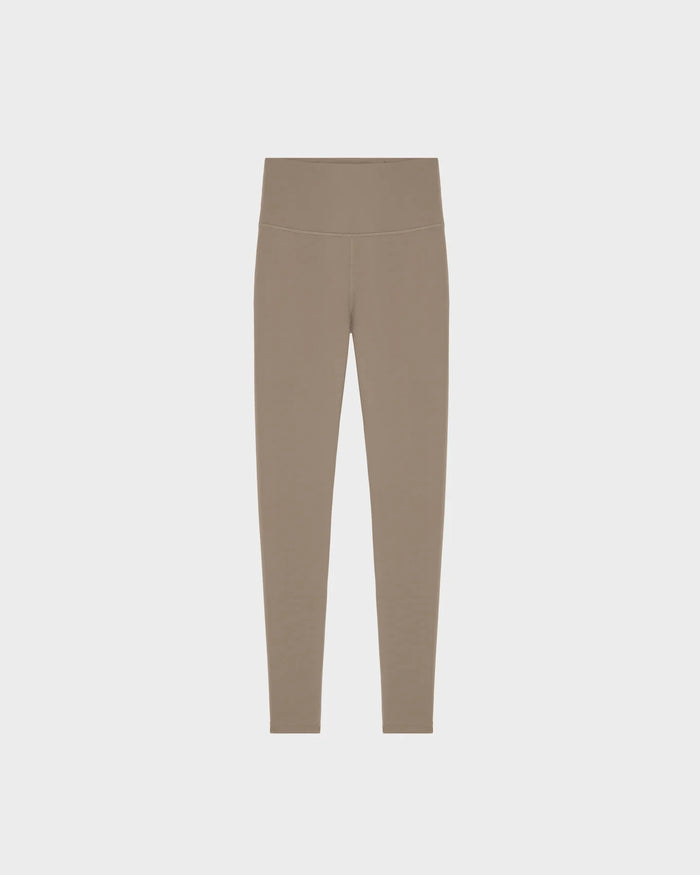 The RIANA - 8524031 Cement leggings by Rudsak are taupe, high-waisted women’s stretch leggings in a seamless, fitted design made from technical performance fabric, shown on a plain light gray background with no visible logos or patterns.