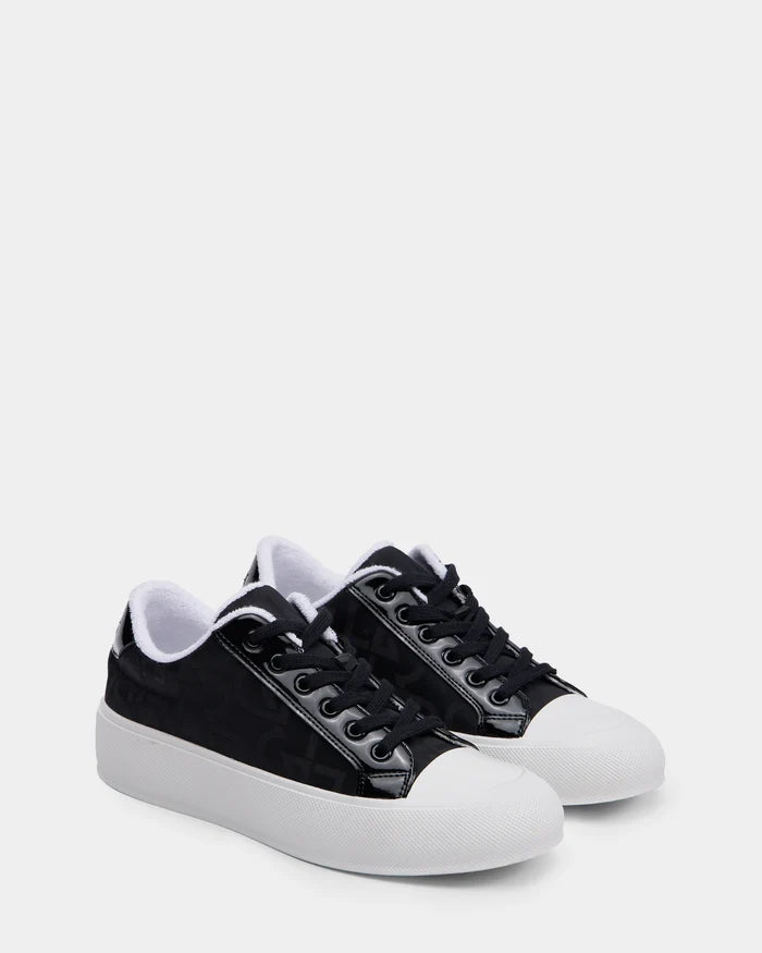 The Rudsak RIMA - 8225001 Black Pattern women’s platform sneakers feature black uppers, white rubber toe caps and soles, black laces, and a white inner lining, shown on a plain light background.