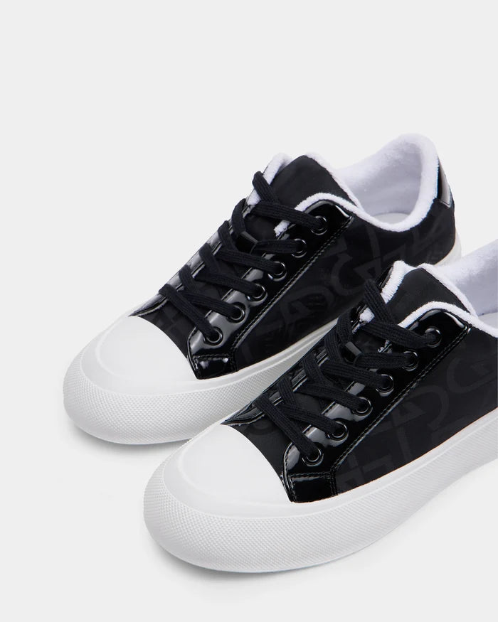 Rudsak’s RIMA - 8225001 Black Pattern sneakers feature vegan leather, black laces, subtle side patterns, and white rubber soles and toe caps, shown against a plain white background.
