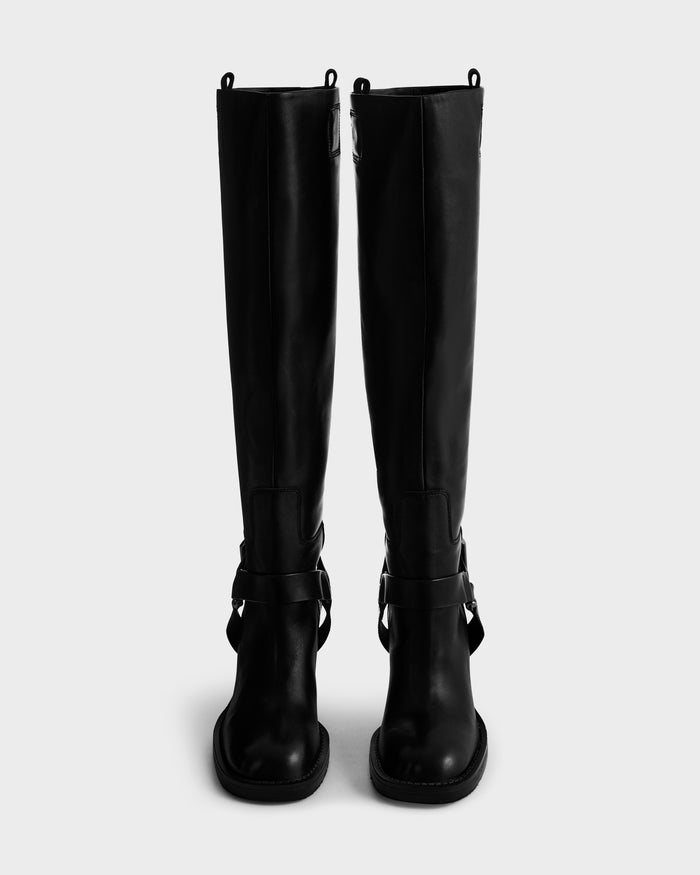 The ROSSEY - 8225574 Black boots by Rudsak are tall black leather boots with round toes, buckled ankle straps, and pull tabs at the top, displayed upright against a plain light gray background.